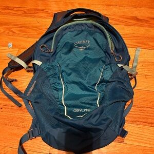 Osprey backpack blue used and has a couple paint stains on front